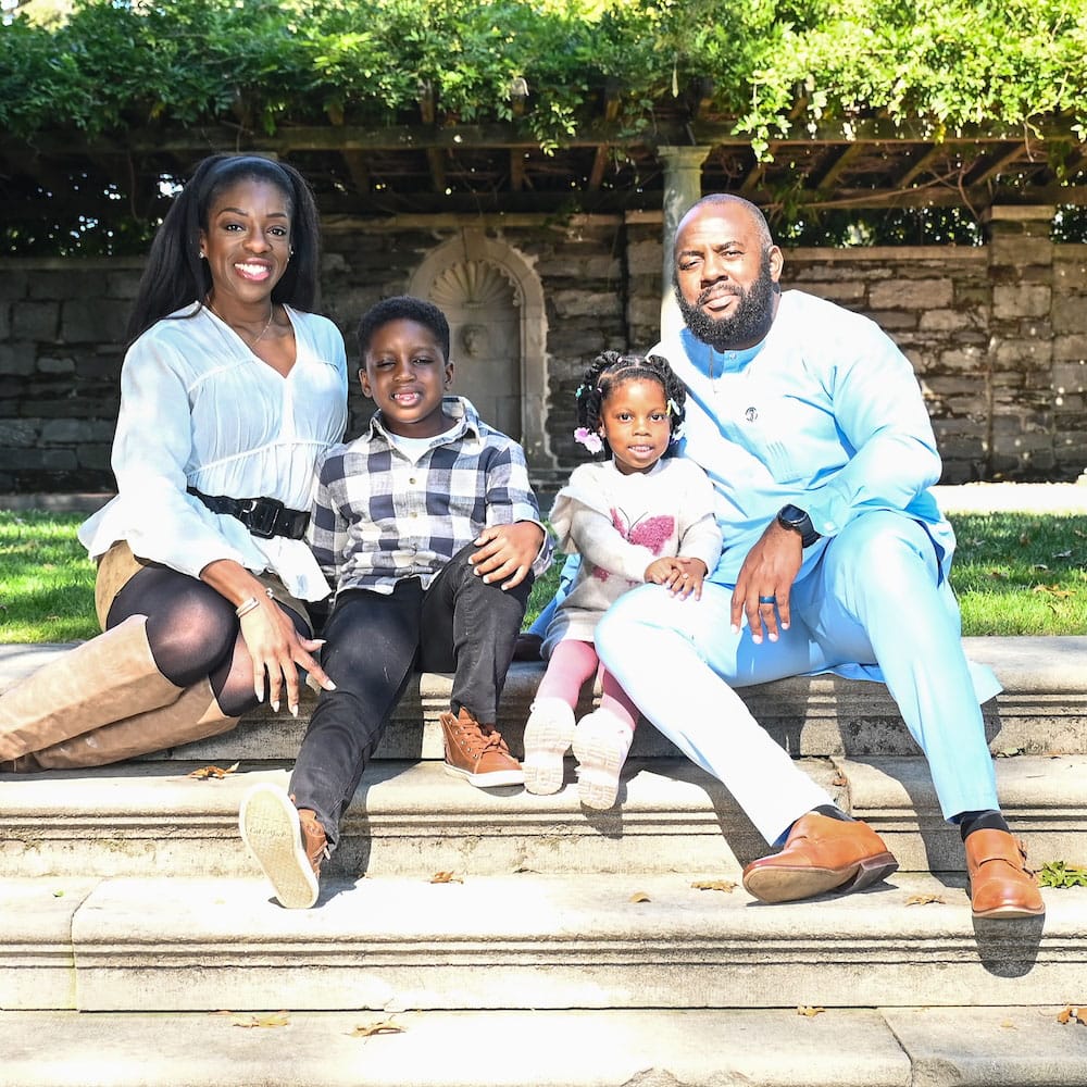 Our pediatric dentist in East Norriton, PA, Dr. Ngozi Okoh sitting with her husband and her baby in a park